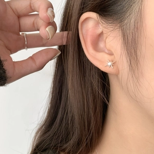 Minimalist S925 sterling silver star stud earrings worn by model for elegant look