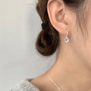 Elegant S925 sterling silver heart earrings with moonstone on a model wearing knitwear