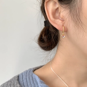 Close-up of S925 silver heart earrings with iridescent moonstone and twisted gold hoop