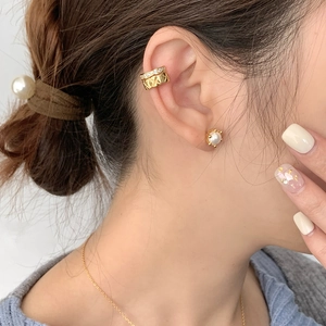 Golden double-layer cross quilted ear cuff and pearl stud earrings set on a model