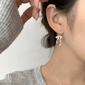S925 silver heart and ribbon bow drop earrings shown on model in a minimalist style
