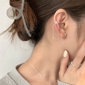 925 silver bow tassel ear cuff set on model with minimalist jewelry styling