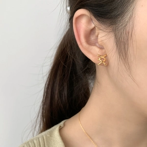 Elegant 925 sterling silver gold-plated cross X-shaped stud earrings on model