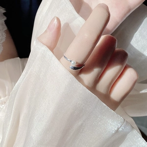 Detail of cross silver ring featuring a 4mm freshwater pearl on model finger