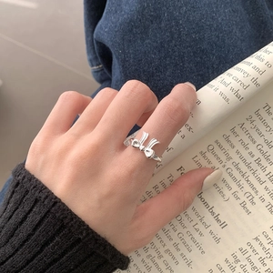 Minimalist S925 sterling silver bow knot open ring on a magazine page background
