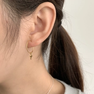 Close-up of a gold S925 sterling silver hoop earring featuring a minimalist star charm