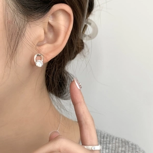 Close-up of elegant S925 sterling silver stud earring with sparkling round zircon stone