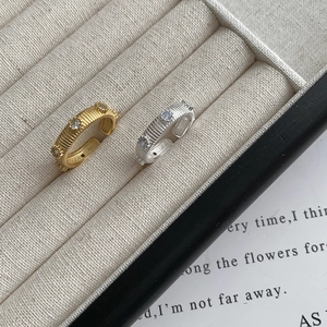 Macro detail of vintage textured S925 silver rings with three inlaid zircons in a gift box