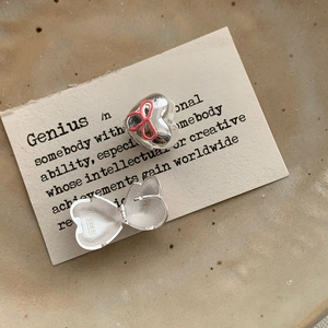 Detail of S925 sterling silver heart locket showing pink bow and inner hallmark