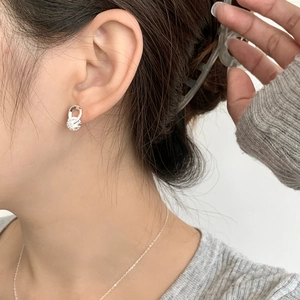 Minimalist S925 sterling silver crisscross stud earrings with sparkling zircon on a model