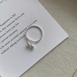 Detailed shot of S925 sterling silver twisted ring with double bell pendant charms