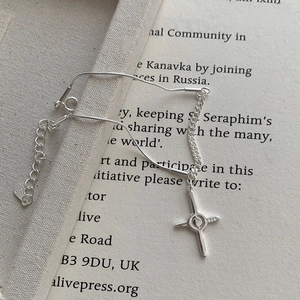Detailed macro view of S925 sterling silver star charm bracelet on vintage book page