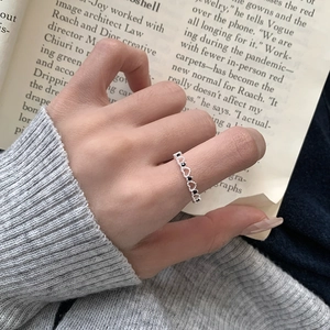 Detail of S925 sterling silver hollow heart ring with micro-set black zirconia stones