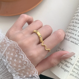 Close-up of vintage gold S925 silver ring set with zircon details and wavy lace texture