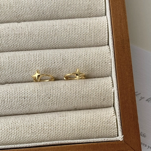 Elegant gold plated S925 silver hoop earrings with polished North Star charms on display