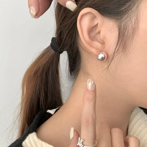 Detail of S925 silver heart butterfly earrings and rabbit open ring on female model