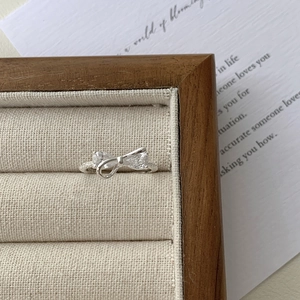 Detail of S925 sterling silver bow ring with pear-cut cubic zirconia and micro-pave setting
