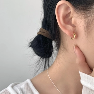 Minimalist S925 sterling silver gold star hoop earring worn by a model for a clean look