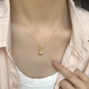 Minimalist S925 sterling silver heart necklace with gold OT buckle on model neck