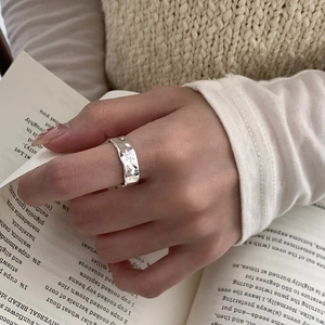 Macro view of S925 sterling silver star ring with hammer texture on a book
