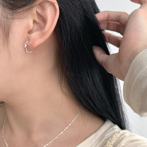 Detailed view of minimalist S925 sterling silver star hoop earrings and fine chain necklace