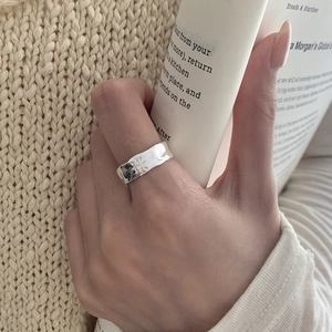 Detail view of S925 sterling silver star ring with crinkle texture on a warm background