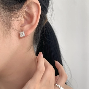 Minimalist S925 sterling silver square stud earring with heart pattern on model