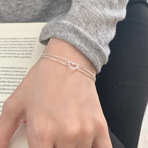 Minimalist S925 sterling silver double-layer bracelet with hollow heart charm on wrist