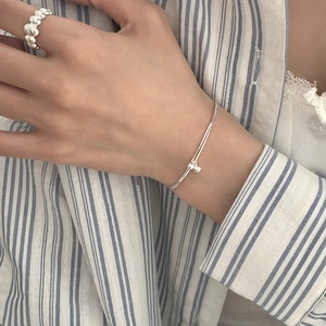 Minimalist S925 sterling silver double-layer bracelet and textured bubble ring worn by model