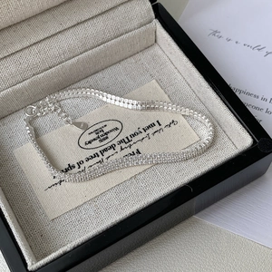 Detail of double-row S925 sterling silver tennis bracelet with sparkling zircons in box