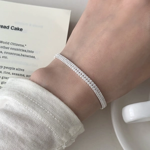 Detail of elegant double-row sparkling cubic zirconia sterling silver bracelet on wrist