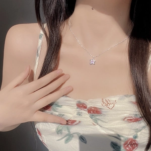 S925 silver star necklace with pink zircon pendant worn by model in soft natural light