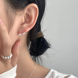 S925 sterling silver bow and tulip stud earrings with a beaded ring on model
