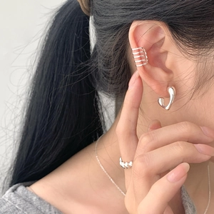 Close-up of S925 sterling silver geometric ear cuff and ring set on model