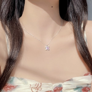 S925 sterling silver star necklace featuring a sparkling pink zircon pendant on a model
