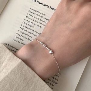 Elegant S925 sterling silver beaded bracelet with heart pendant worn on wrist