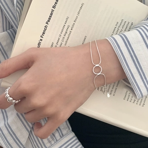 Detailed close-up of a double-layer S925 sterling silver chain bracelet with round charm