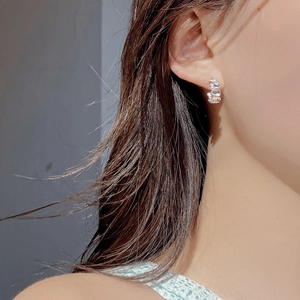 Detailed view of S925 sterling silver oval stud earrings with sparkling zircon stones