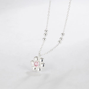 925 sterling silver flower necklace with a pink gemstone pendant on a white background
