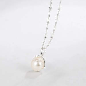 Elegant S925 sterling silver necklace featuring a round white pearl on a beaded chain
