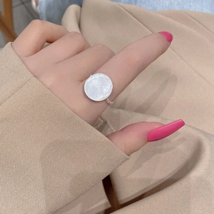 Minimalist S925 sterling silver ring with a large brushed circular disc on a female hand