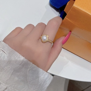 Detail of S925 silver pearl ring with lava texture and gold finish on model finger