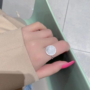 Close-up of a brushed S925 sterling silver geometric round ring with an adjustable band