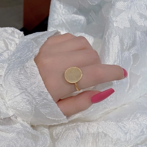 Detailed view of a gold S925 sterling silver ring with a brushed circular geometric disc