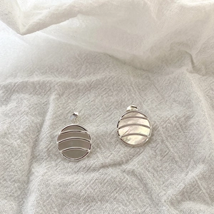 Detail view of S925 silver round geometric earrings with white mother of pearl and grey stone