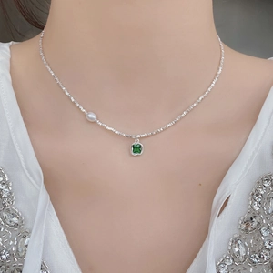 S925 sterling silver necklace with emerald zircon pendant and a single pearl accent