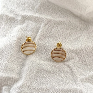 Close-up of S925 sterling silver geometric stud earrings with white mother-of-pearl inlay
