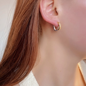 Close-up of S925 silver square hoop earrings with hammered texture and two-tone gold finish