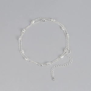 Macro shot of S925 sterling silver cylinder beads with spiral texture on double chain