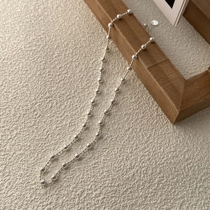Elegant S925 sterling silver bead necklace with adjustable extension on wood background